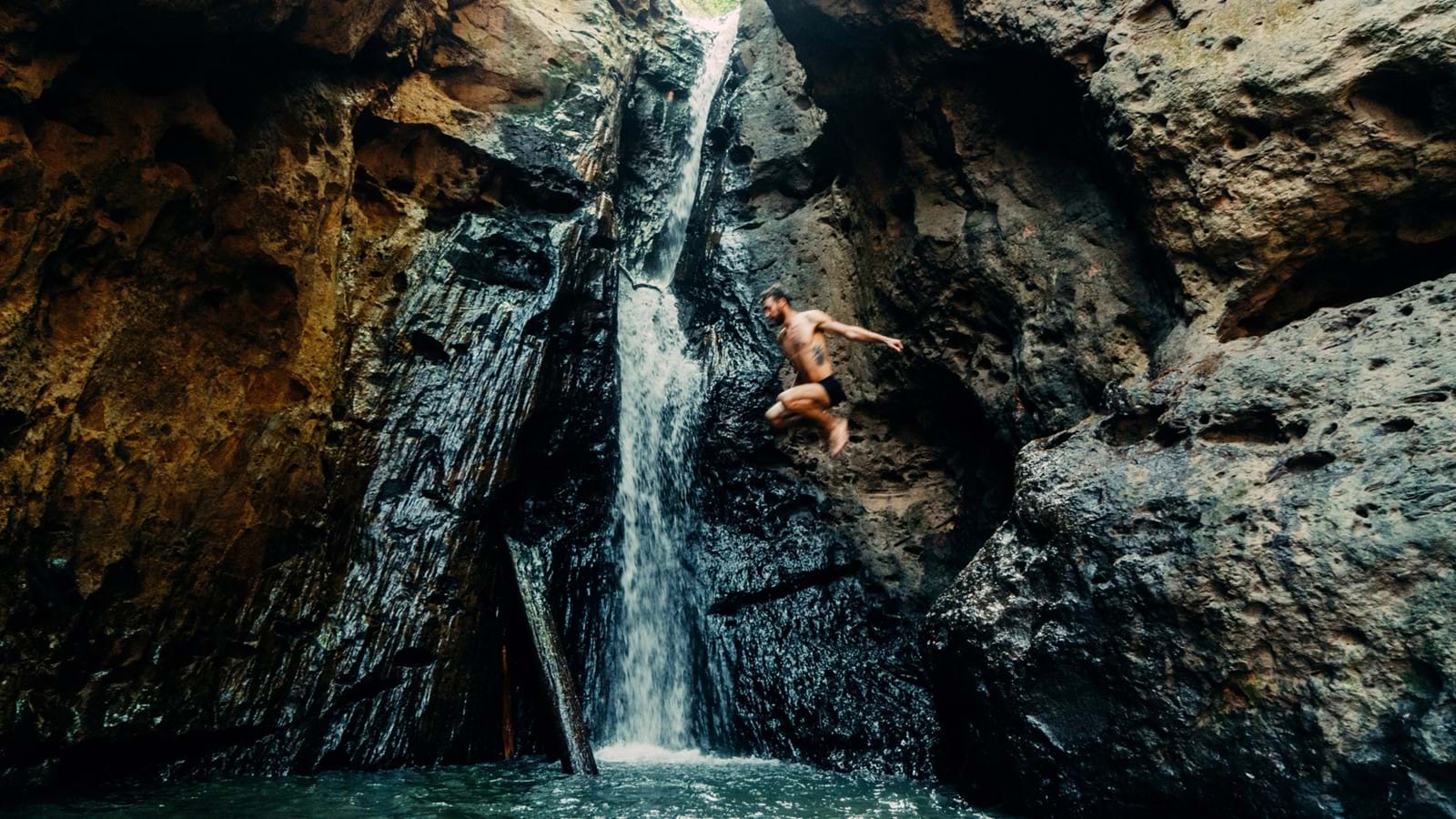 Man jumping off a waterfall represent migrating from Jive