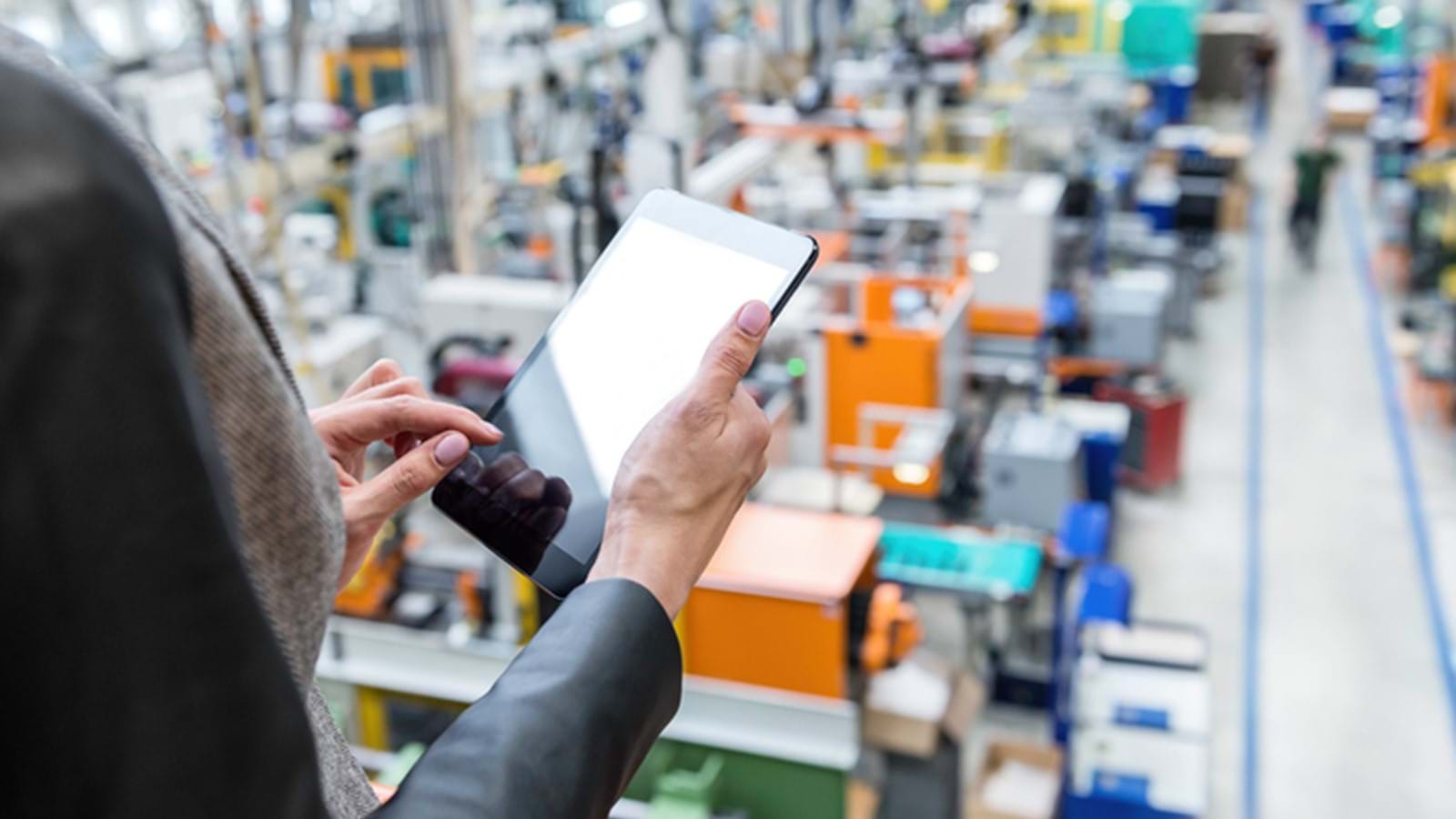 Factory worker accessing their intranet through a mobile device 