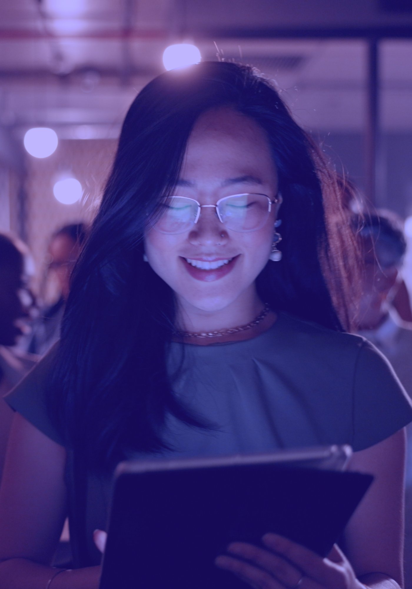 woman smiling at an ipad