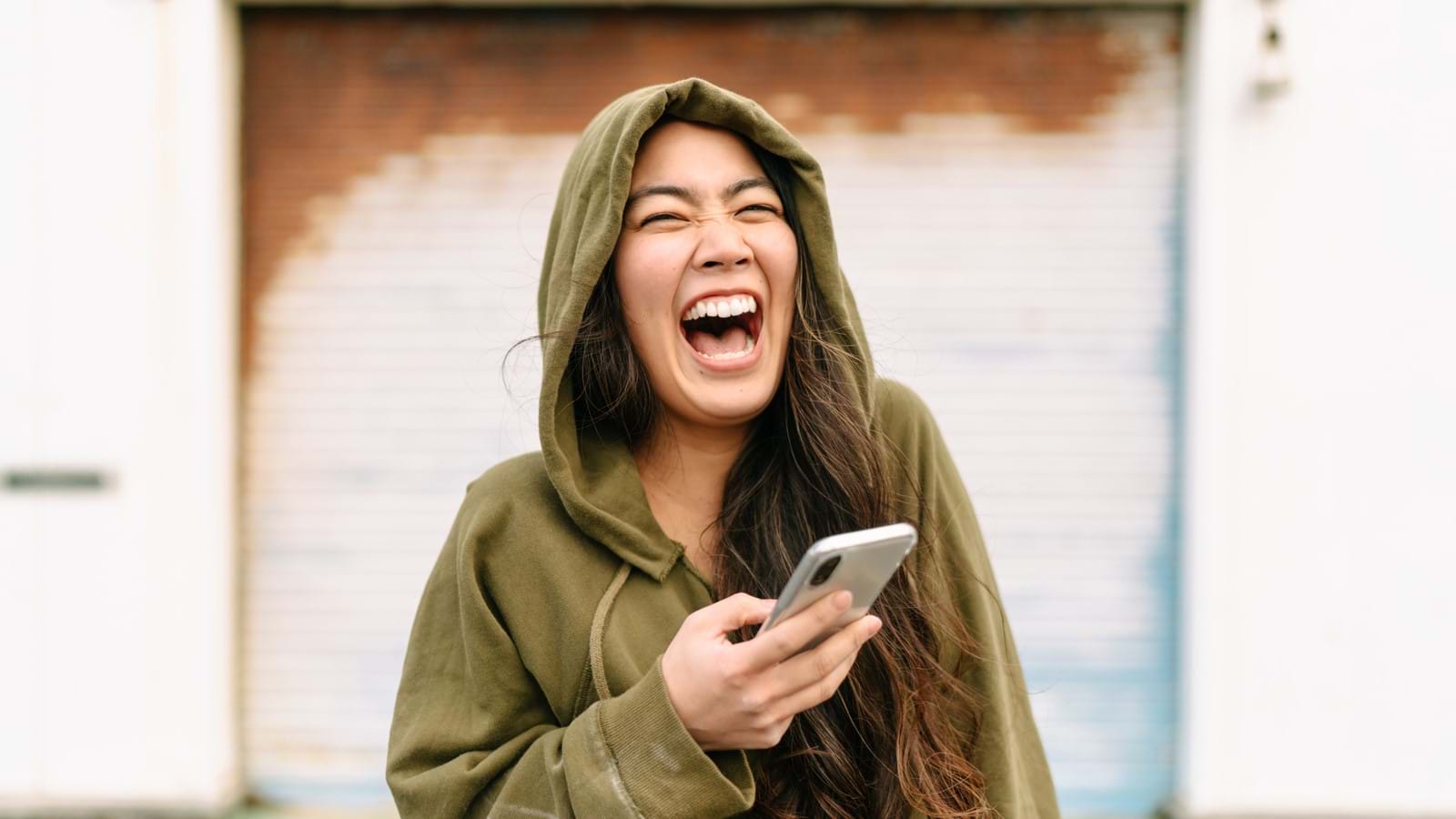 Woman smiling using mobile phone