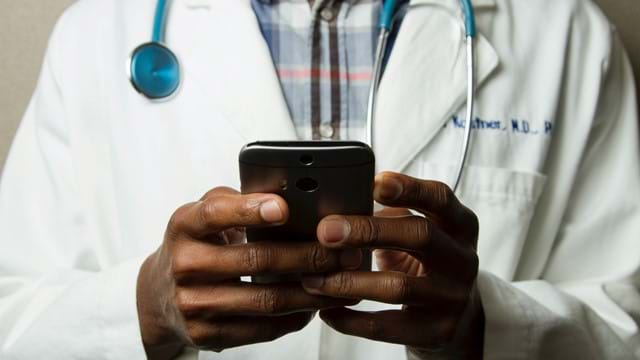 Doctor looking at healthcare intranet on mobile