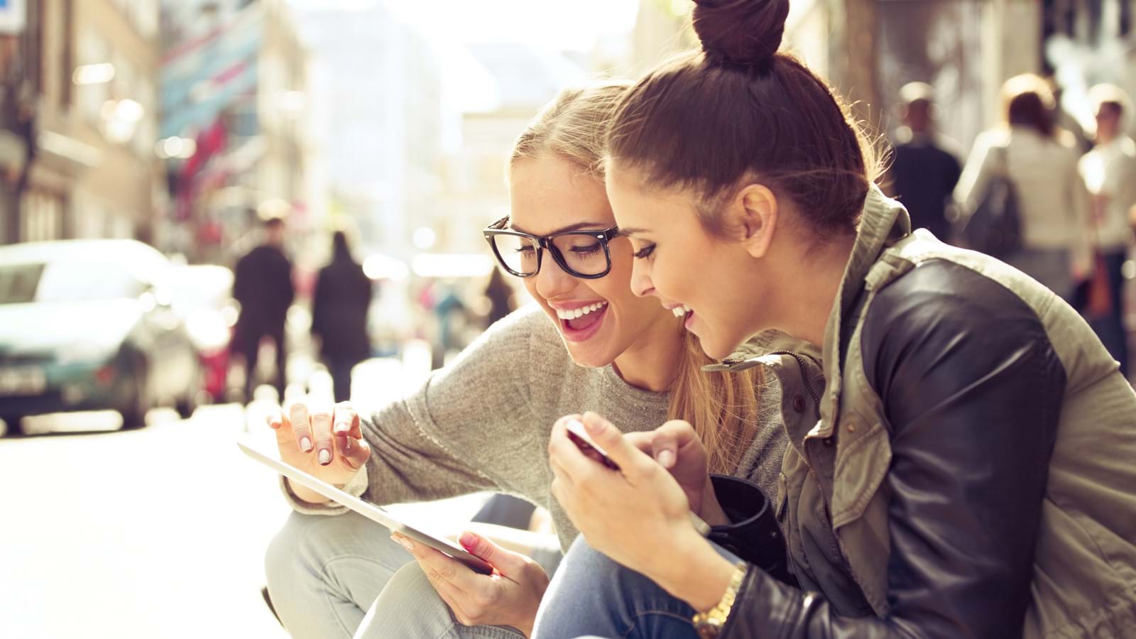 Two females looking at a mobile screen