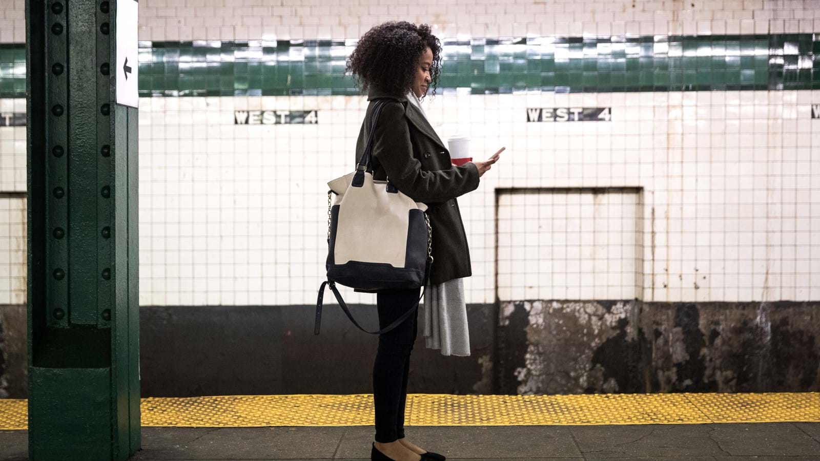 Woman using cloud-based intranet app at subway station