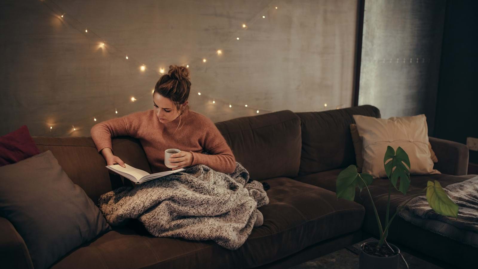 Woman sits in ultimate hygge room